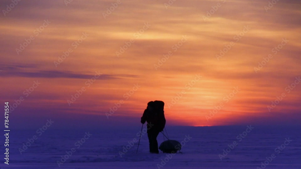 One man go to sunset on snow desert One man go to sunset on snow desert