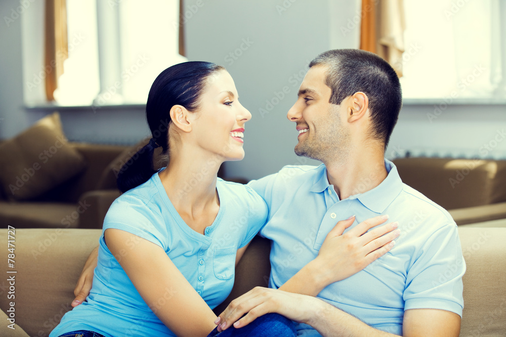 Cheerful smiling young attractive couple, indoors Cheerful smiling young attractive couple, indoors