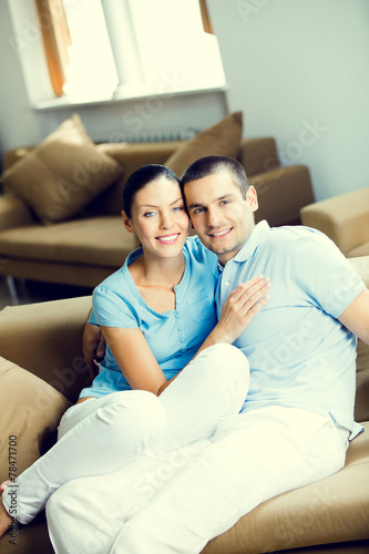 Cheerful smiling young attractive couple, indoors