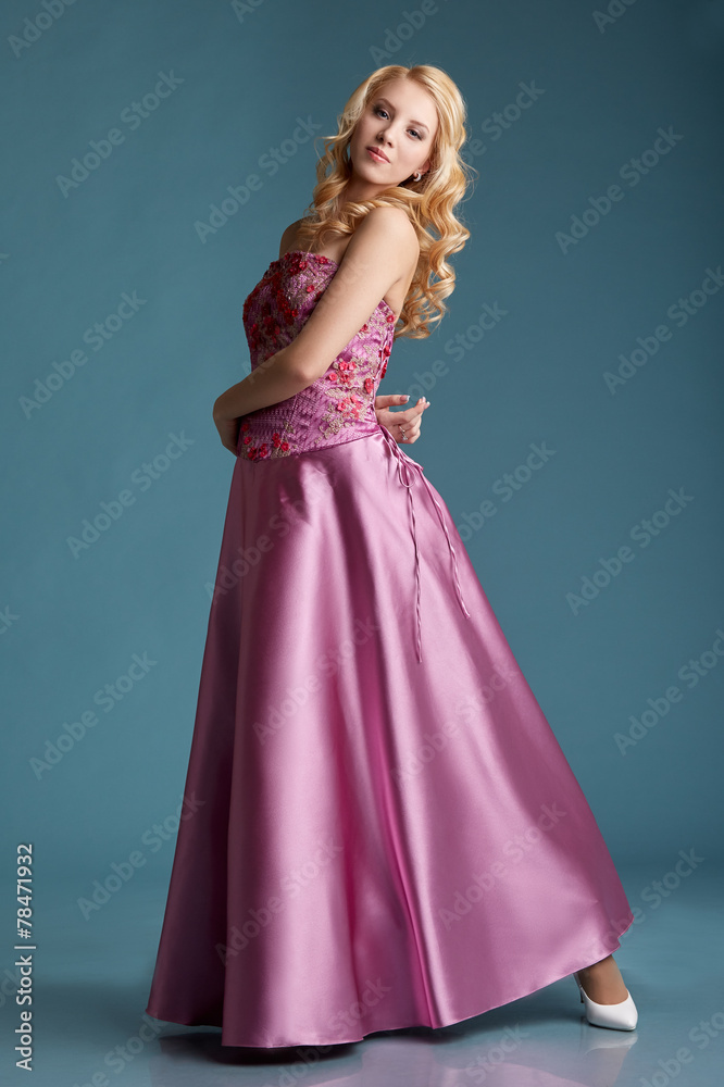 Beautiful young girl posing in long pink dress Beautiful young girl posing in long pink dress