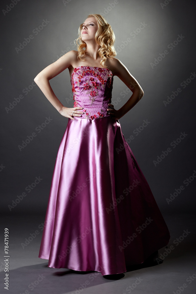 Studio photo of majestic blonde in pink dress