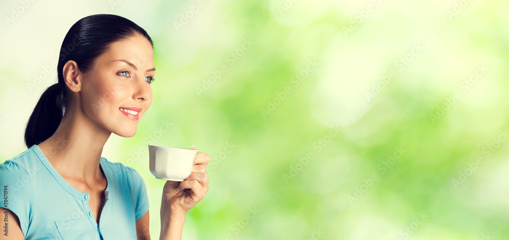 Portrait of smiling young woman drinking coffee Portrait of smiling young woman drinking coffee
