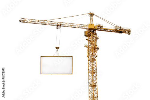 single yellow hoisting crane and advertisement hoardin