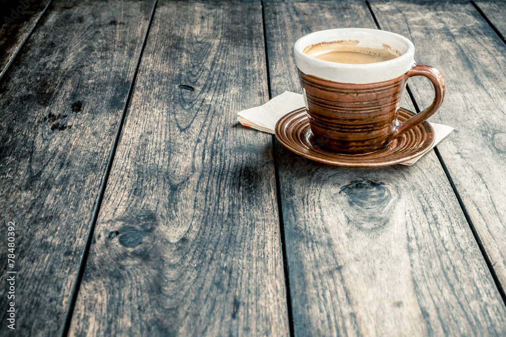 Obraz premium Coffee cup on old wooden table