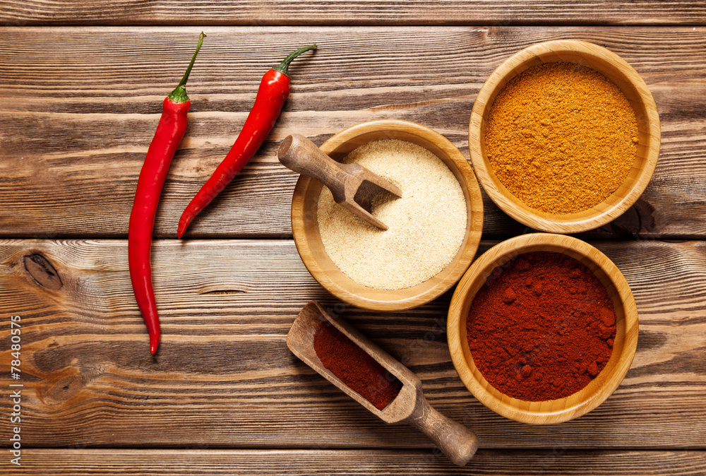 Assortment of spices on a wooden table Assortment of spices on a wooden table