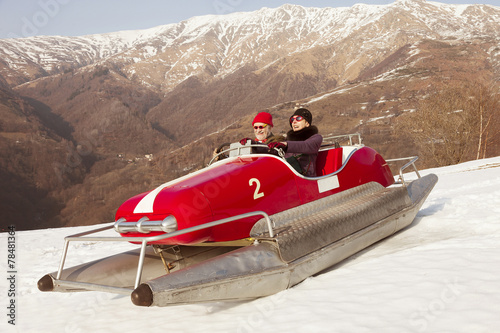 Sweet and weird couple surfing on a pedalos in winter time