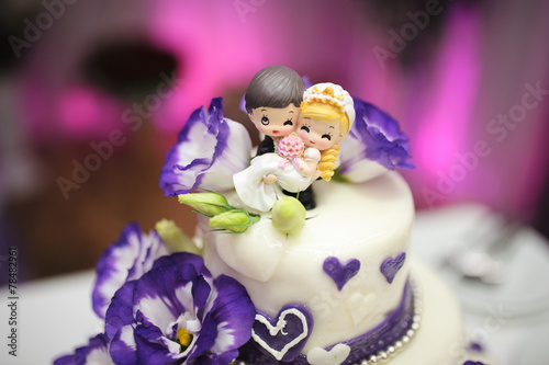 Wedding cake decorated with beautiful violet flowers. © eugenelucky