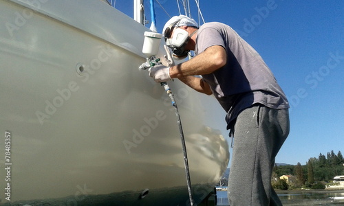 worker man painting boat with spray gun © William Richardson