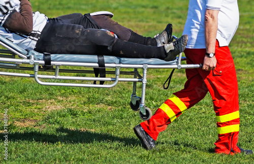 Medic takes care of the injured football player