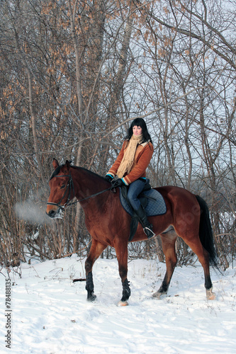 Equestrian girl in winter woods