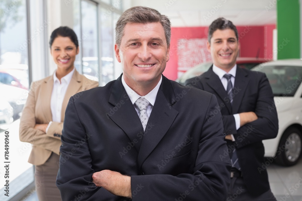 Smiling business team standing with arms crossed Smiling business team standing with arms crossed