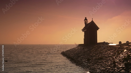 Beacon at the Ijsselmeer at sunset. Volendam, The Netherlands