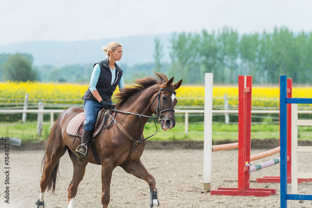 Young woman riding a horse