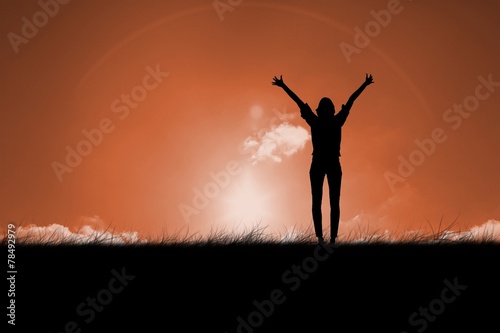 Composite image of silhouette of cheering woman