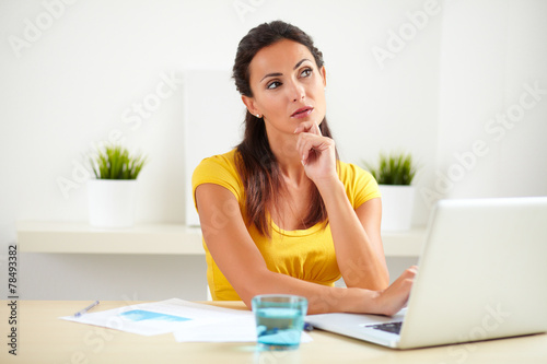 Lovely secretary wondering while sitting in office
