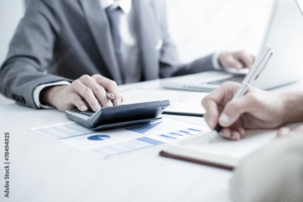 Business people discussing the charts and graphs showing the res Business people discussing the charts and graphs showing the res