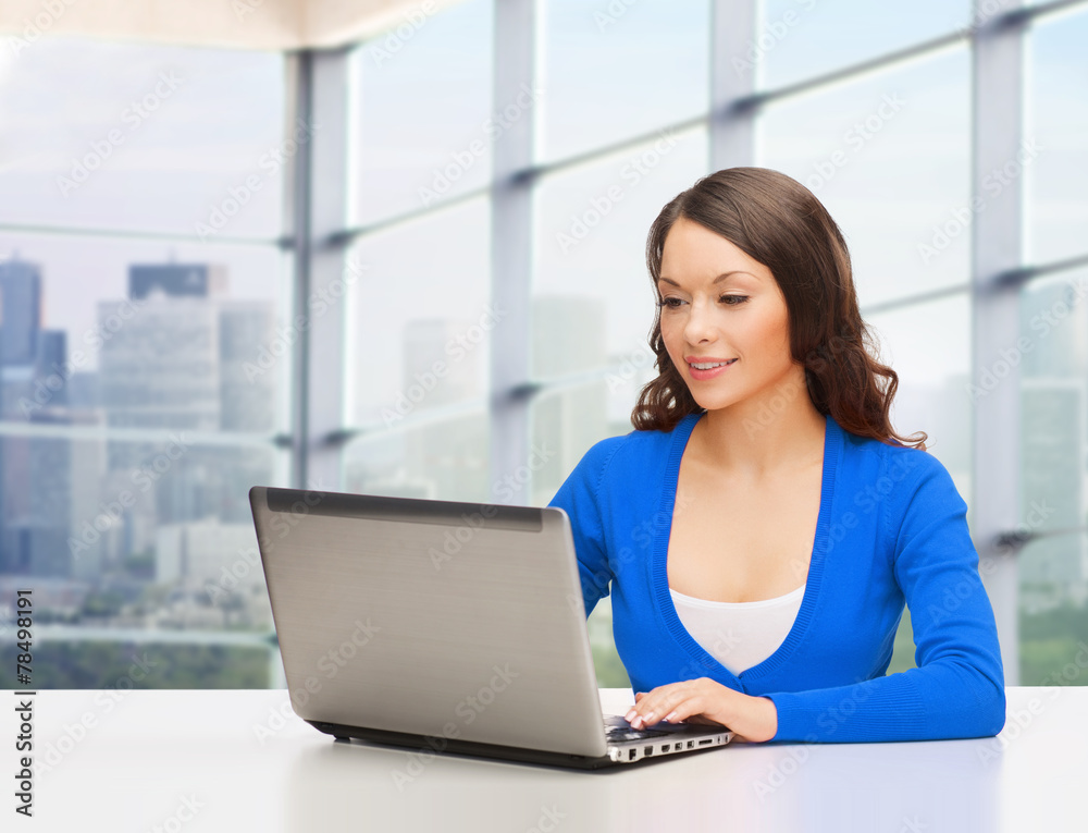 smiling woman in blue clothes with laptop computer smiling woman in blue clothes with laptop computer