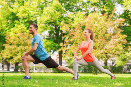 smiling couple stretching outdoors