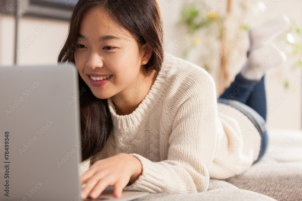 Asian young woman is working with her computer at home on her so Asian young woman is working with her computer at home on her so