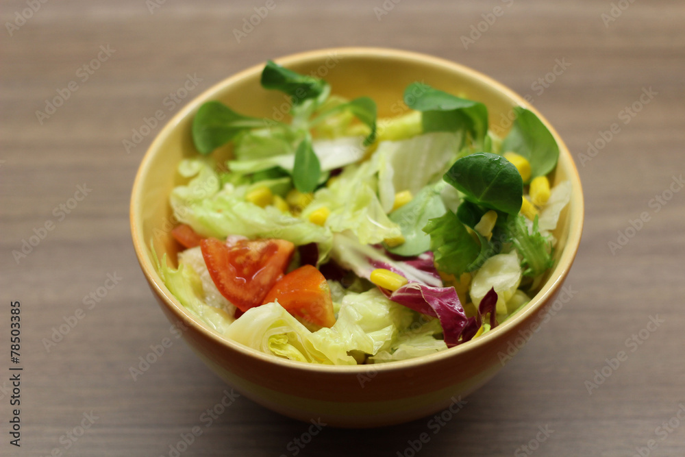 Mixed leaves and tomato salad in a bowl Mixed leaves and tomato salad in a bowl