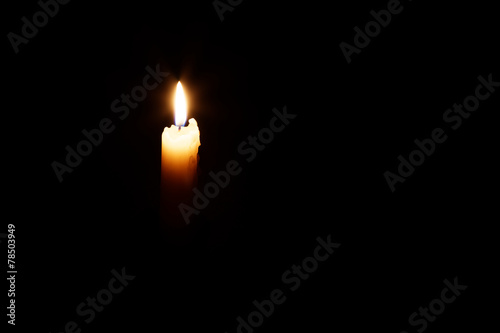 Glowing candle in the dark