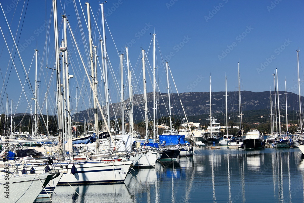 Yachts and sail boats reflected in a Marina	
