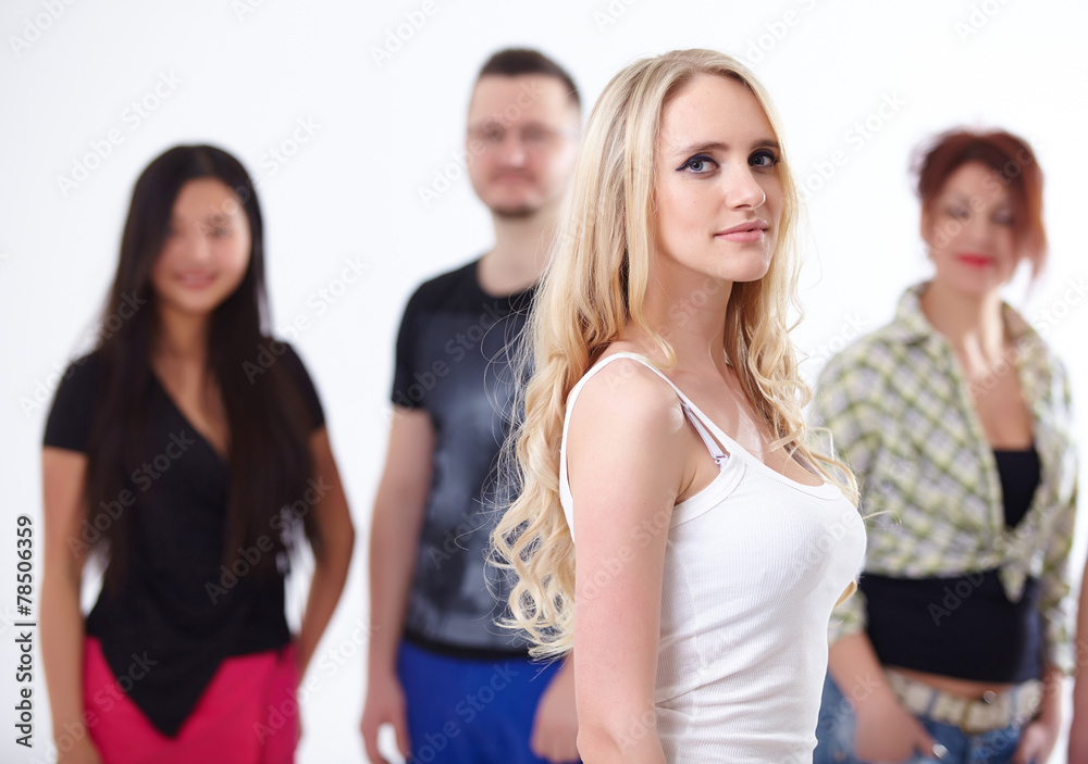 young blond woman on the background of a group of students young blond woman on the background of a group of students