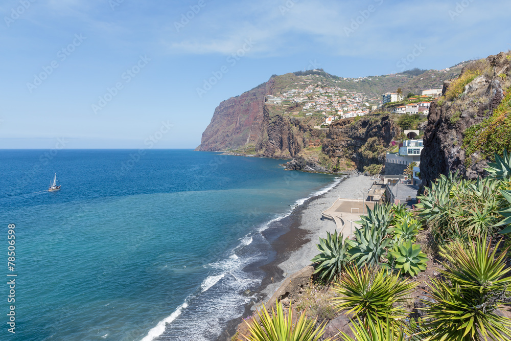 Coast of Madeira island with hiigh cliffs and small villages