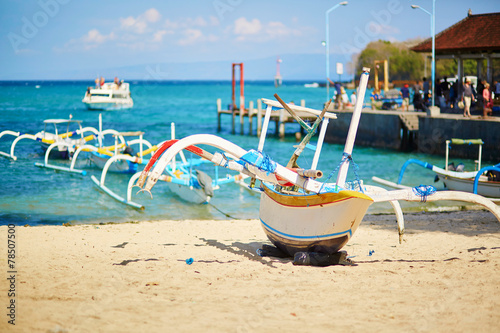 Bangka boats on the sea shore in Balinese village photo
