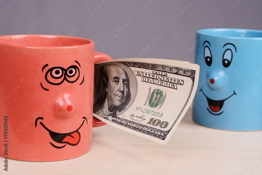 Cup with dollars money in the hand