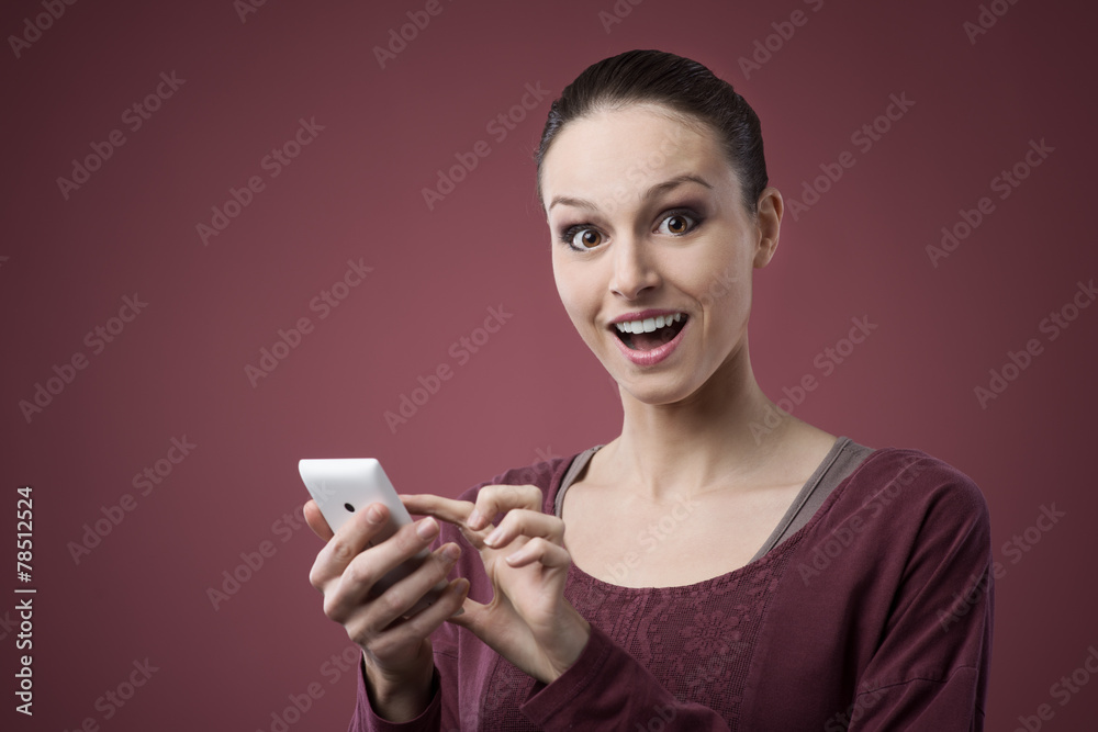 Surprised young woman using mobile phone Surprised young woman using mobile phone