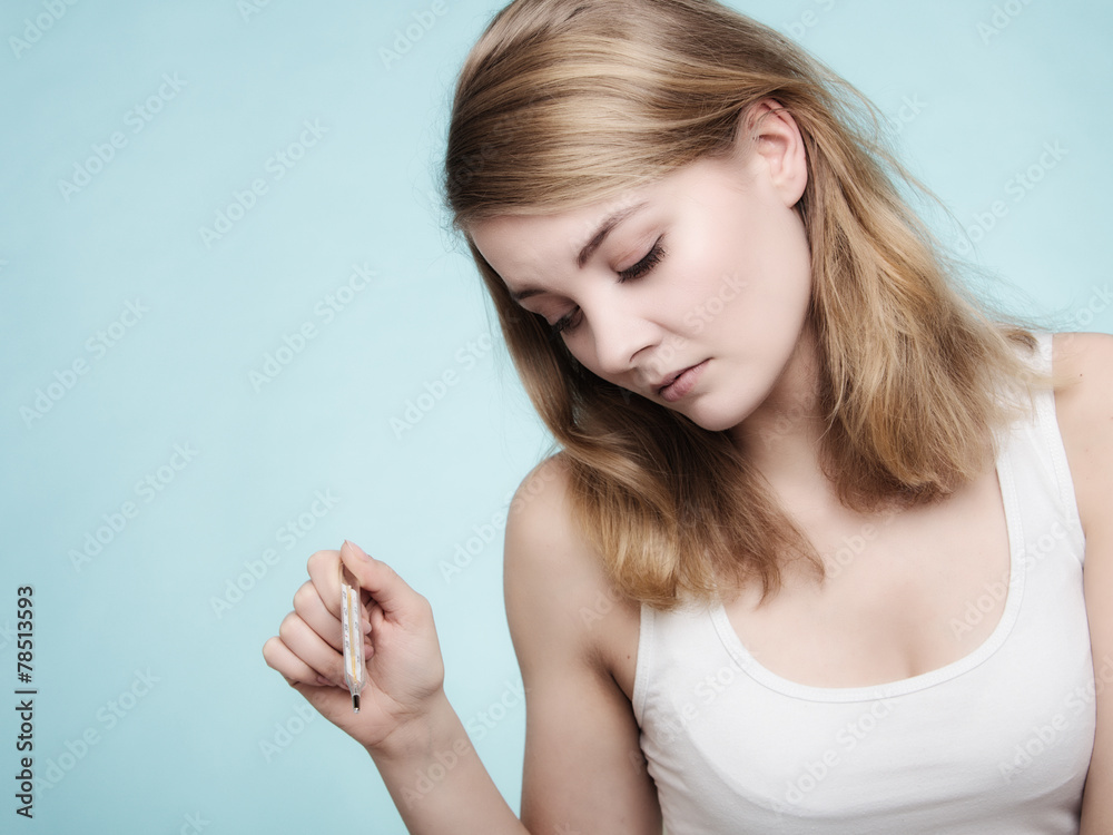 Flu. Sick girl with fever checking thermometer. Flu. Sick girl with fever checking thermometer.