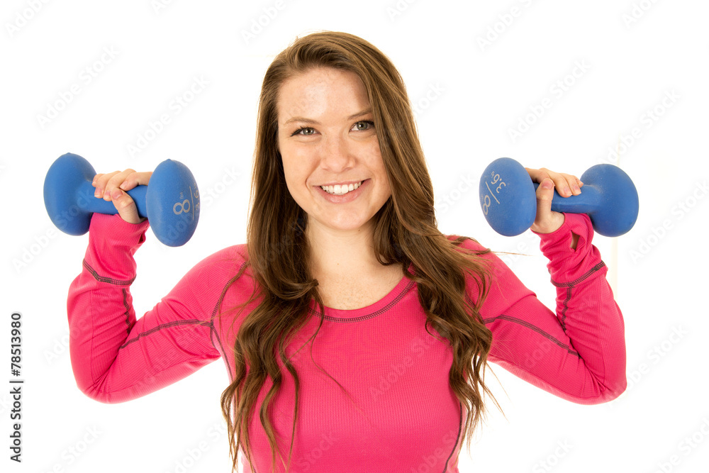 Young brunetter female model lifting barbells happy smiling Young brunetter female model lifting barbells happy smiling