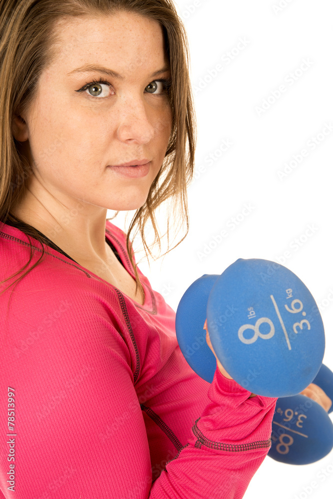 Portrait of a female model lifting blue barbells Portrait of a female model lifting blue barbells