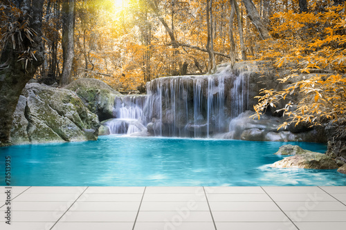 Waterfall, green forest in Erawan National Park in Thailand montage with tile floor. Landscape with water flow, tree, river, stream and rock at outdoor. Beautiful scenery of nature for vacation. © DifferR