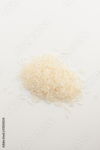 white rice spilled on white background photo