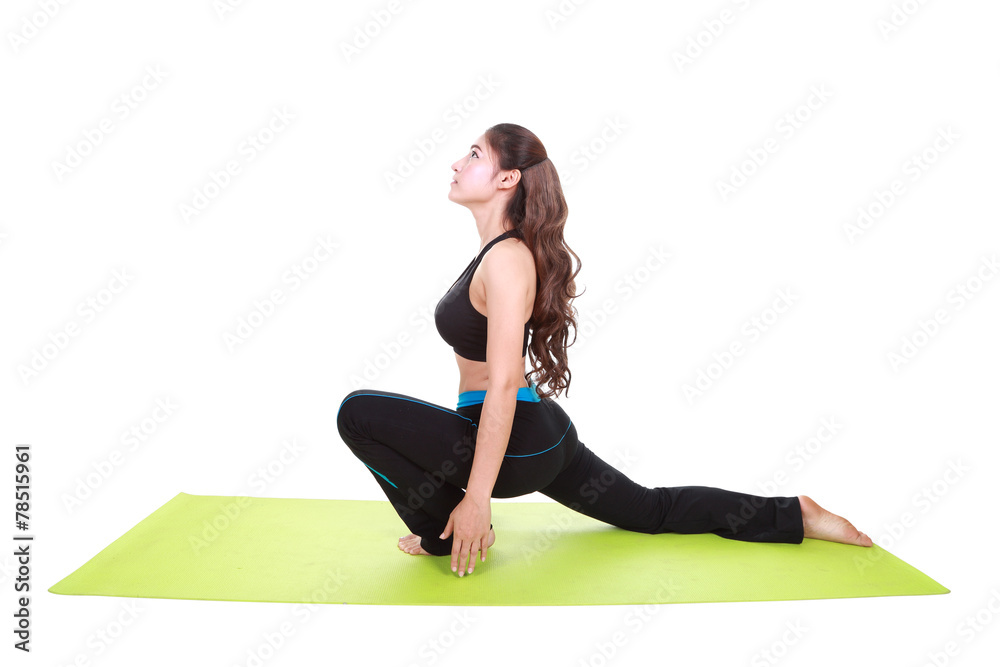 Fototapeta premium Young woman doing yoga exercise with yoga mat
