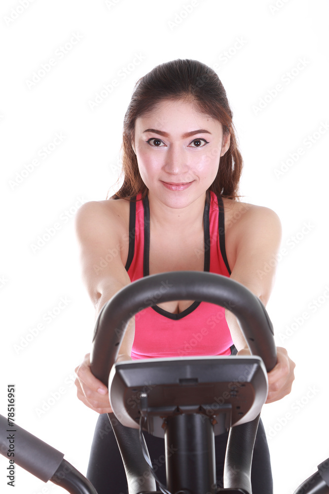 young woman doing exercises with exercise machine young woman doing exercises with exercise machine