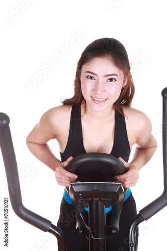 young woman doing exercises with exercise machine © geargodz