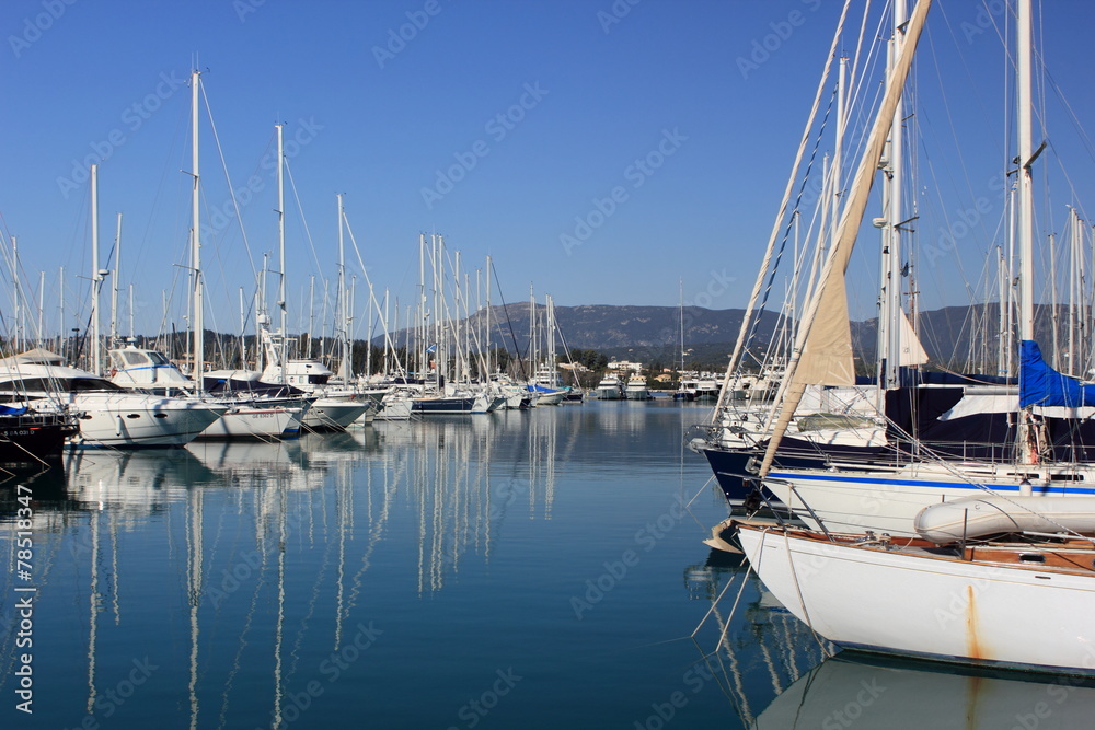 Yachts and sail boats reflected in a Marina