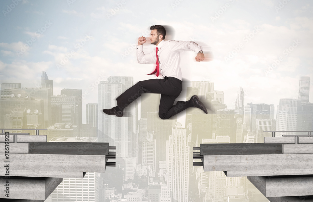 Energetic business man jumping over a bridge with gap Energetic business man jumping over a bridge with gap