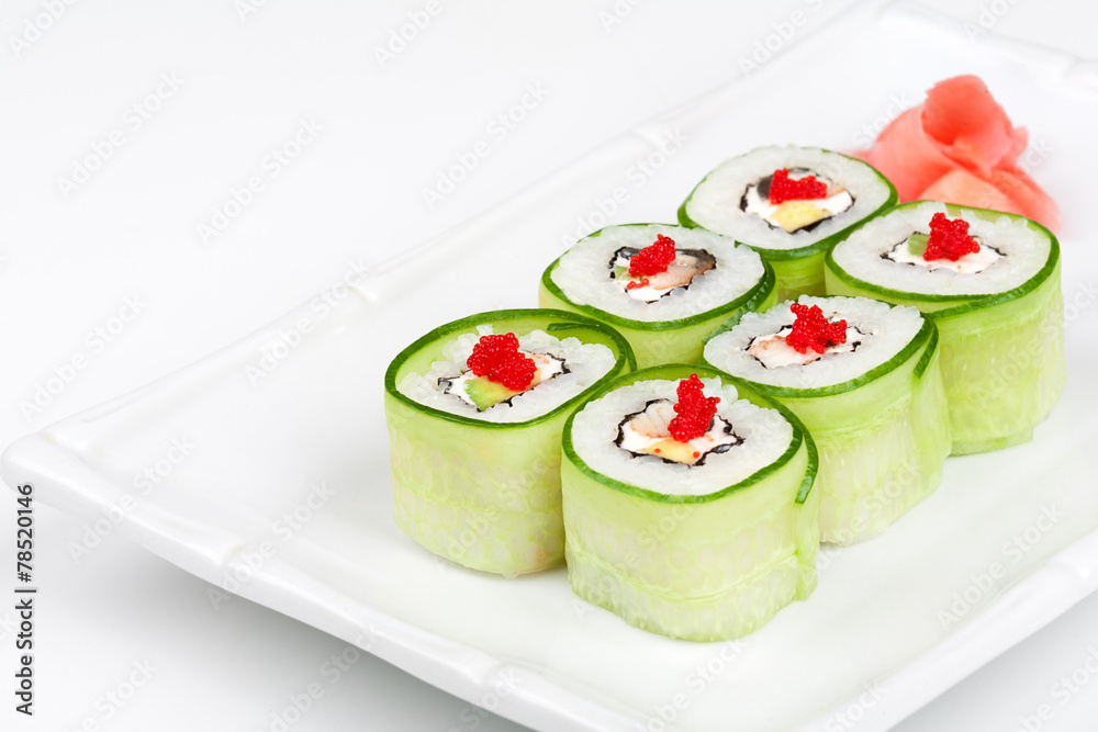 Sushi roll with avocado, cucumber and caviar.