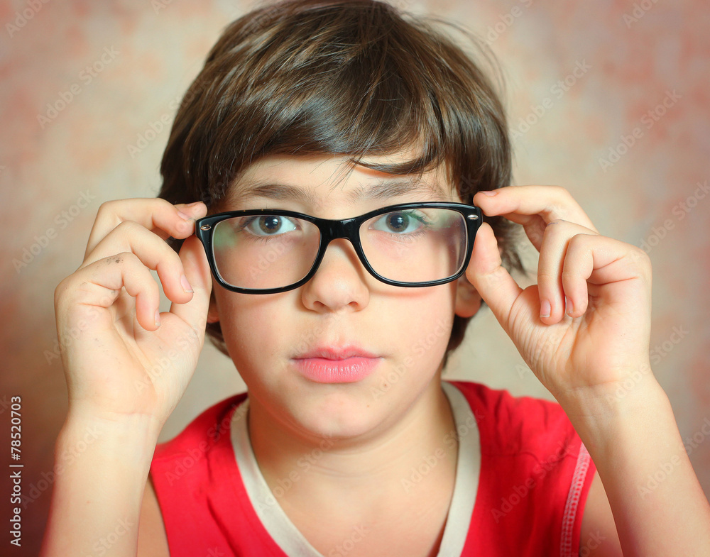 handsome preteen boy with correction myopia glasses