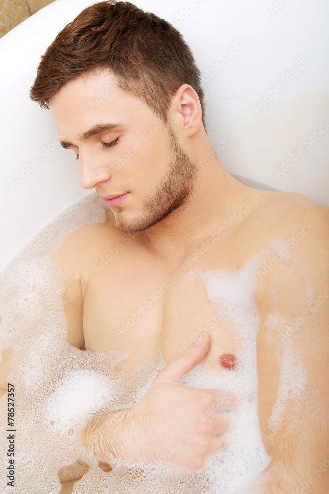 Handsome man taking a bath. Handsome man taking a bath.