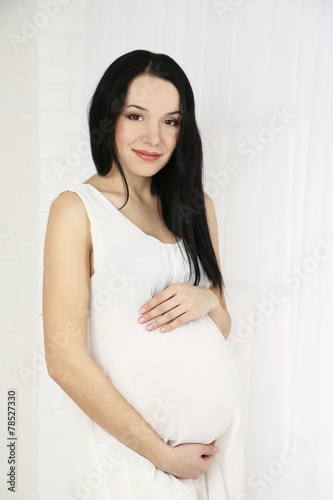 Young pregnant woman on light background Free Download Young pregnant woman on light background - GFXLoad