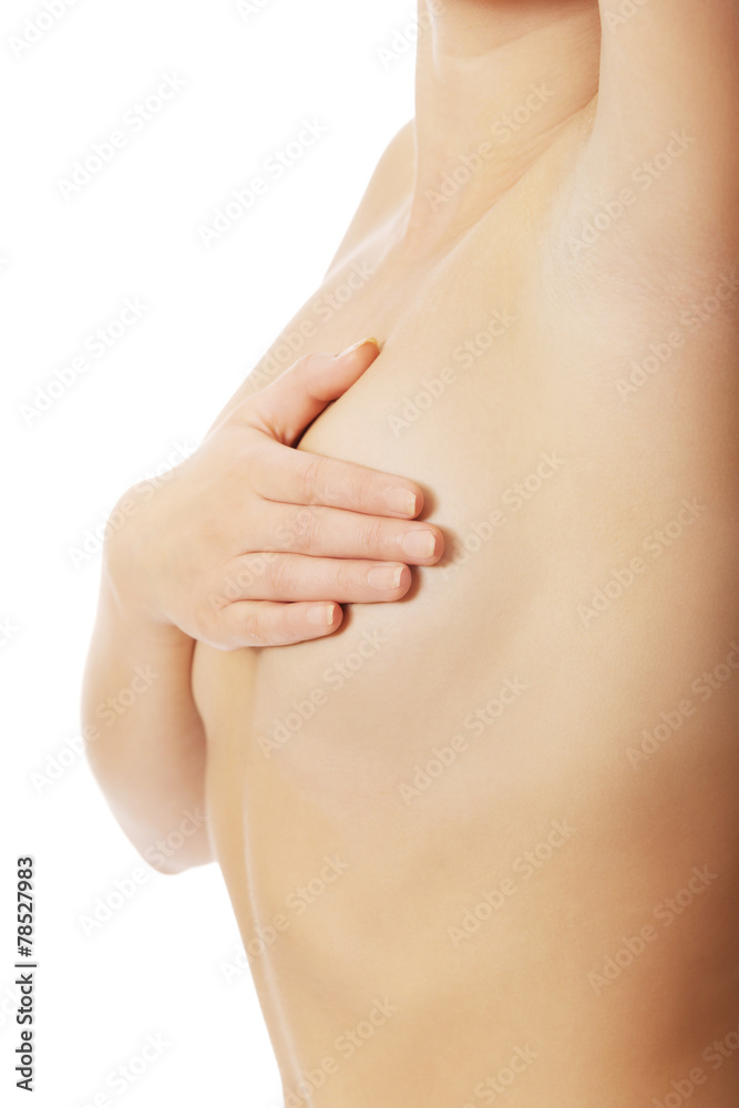 Woman examining her breast.