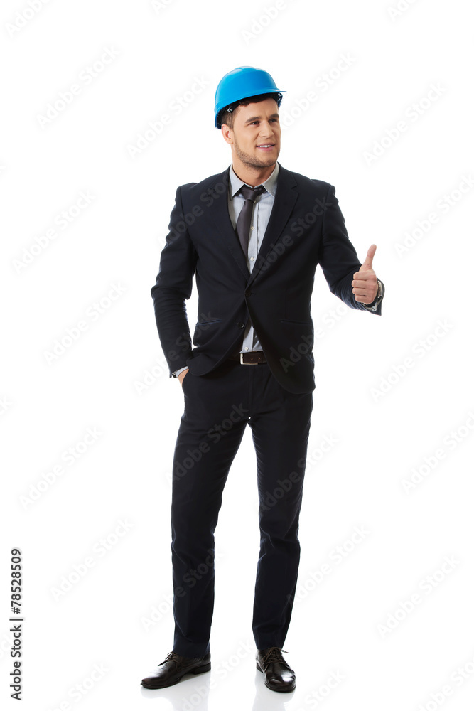 Businessman in hard hat showing thumbs up. Businessman in hard hat showing thumbs up.