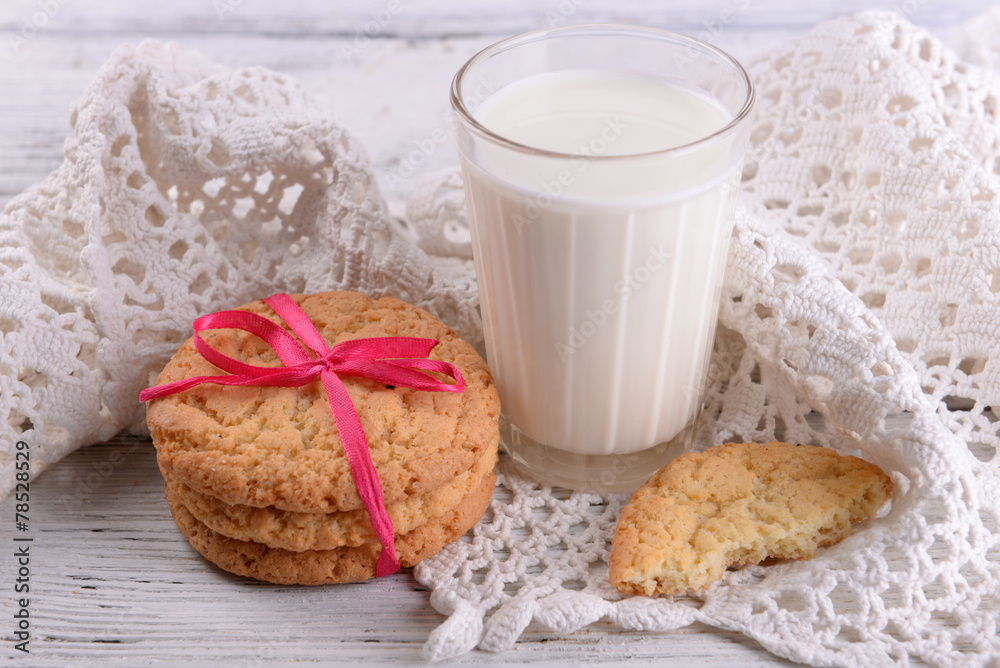 Tasty cookies and glass of milk on color wooden background Tasty cookies and glass of milk on color wooden background
