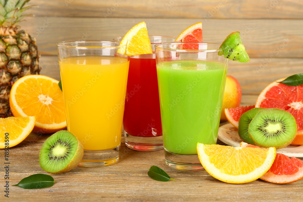 Fresh juices with fruits on wooden table Fresh juices with fruits on wooden table