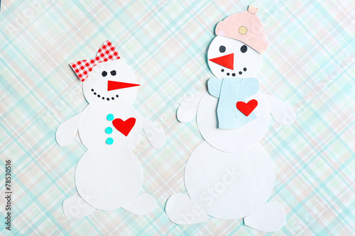 Handmade snowmen on bright background
